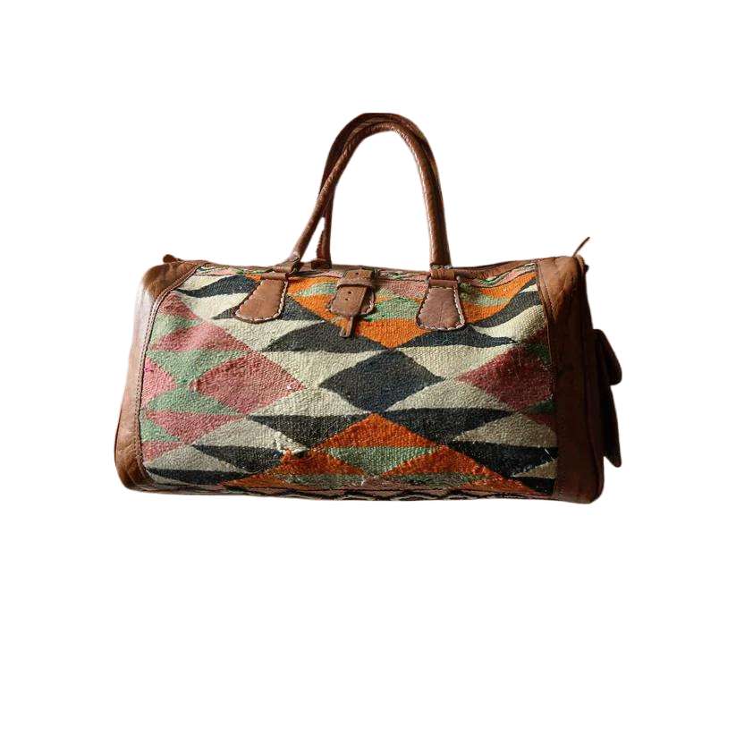 Multicolored geometric patterned bag with brown leather accents on a white background - Bespoke Handcrafted KilimBags